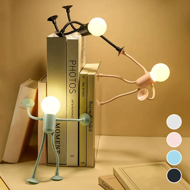 Trois veilleuses allumées contre une pile de livres, dont une poussant les livres, avec pastilles des quatre coloris disponibles. 5