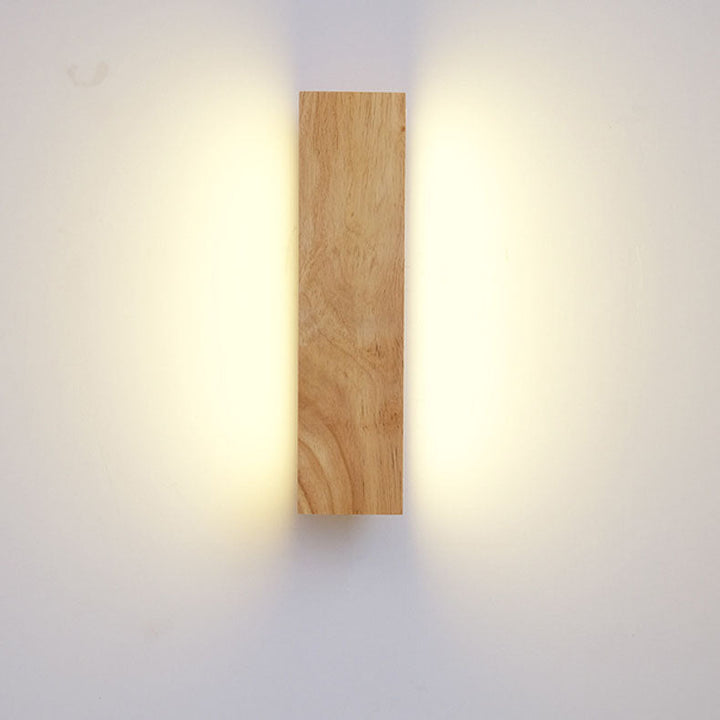 Applique en bois vue de face en position verticale, allumée, diffusant une lumière chaude de chaque côté. 3