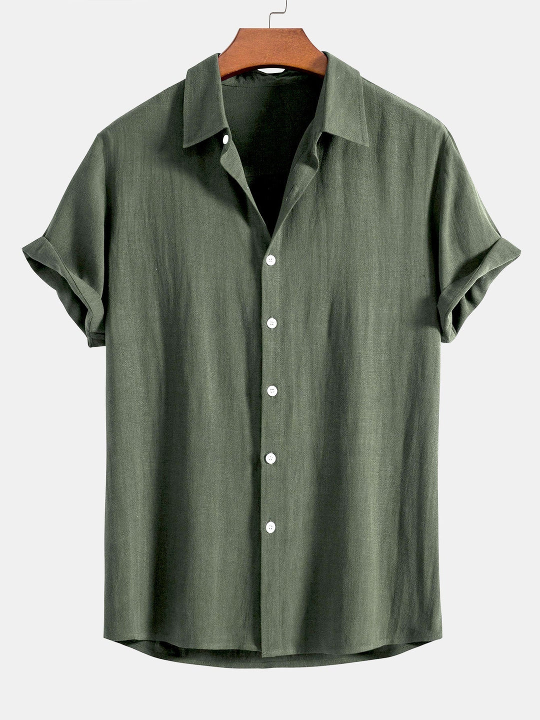 Chemise à manches courtes retroussées, coloris vert kaki, sur cintre en bois, vue de face avec boutons blancs. 5