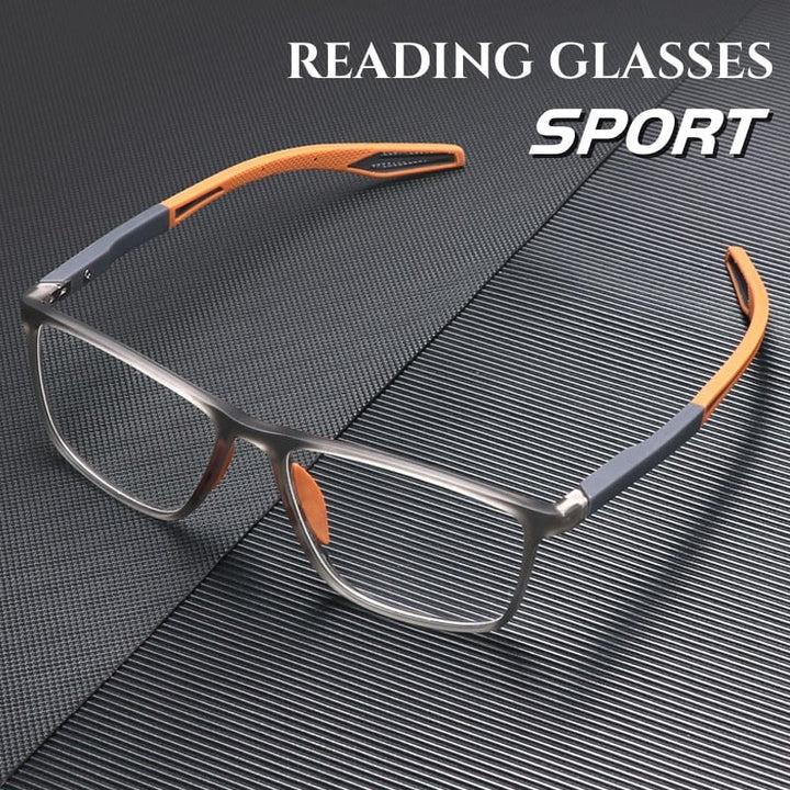 Lunettes à monture rectangulaire grise translucide et branches sport orange et grises, posées sur une surface texturée sombre. 1