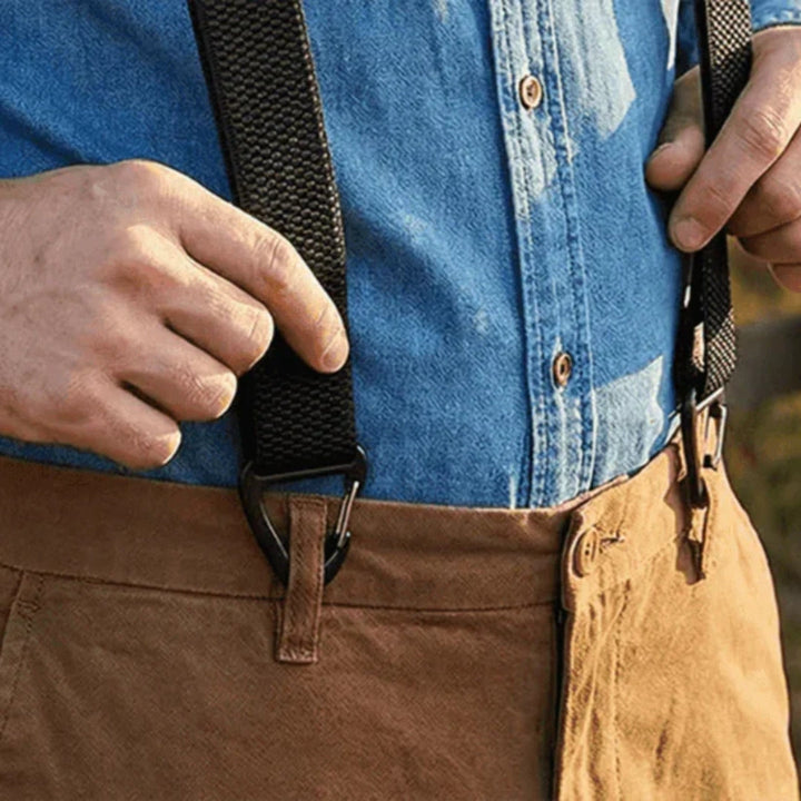 Gros plan d'une main tenant une bretelle noire dont la pince est fixée à un pantalon 17