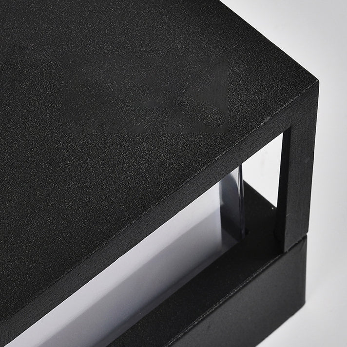 Gros plan sur l'angle du capot noir texturé de la lampe, avec le diffuseur translucide visible en dessous. 5