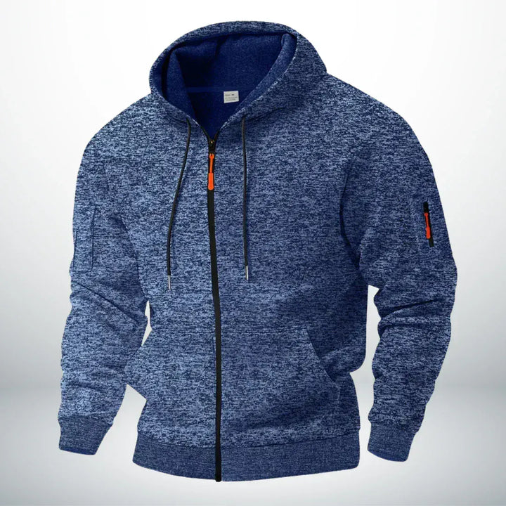 Sweat zippé chiné bleu vu de trois quarts, avec cordons de capuche, tirette orange et petite poche zippée sur la manche. 1