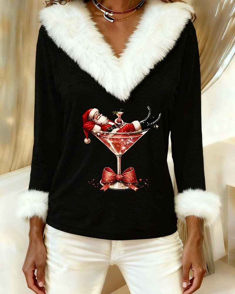 Gros plan sur l'imprimé du Père Noël dans un verre à cocktail avec nœud rouge, sur haut noir 9