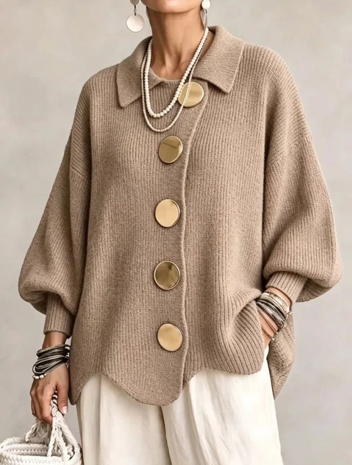 Cardigan beige taupe en maille côtelée à boutons dorés, porté avec un pantalon écru et plusieurs bracelets. 7