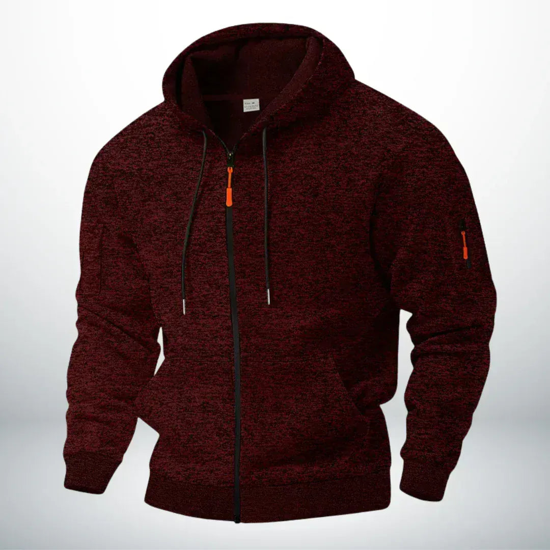 Même sweat zippé à capuche en chiné bordeaux foncé, vu de trois quarts sur fond clair, poche de manche zippée visible. 2