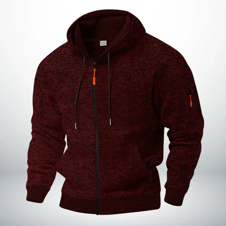 Même sweat zippé à capuche en chiné bordeaux foncé, vu de trois quarts sur fond clair, poche de manche zippée visible. 2