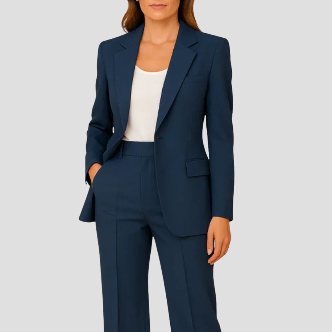 Femme portant le tailleur bleu marine sur un haut blanc, une main dans la poche du pantalon 1