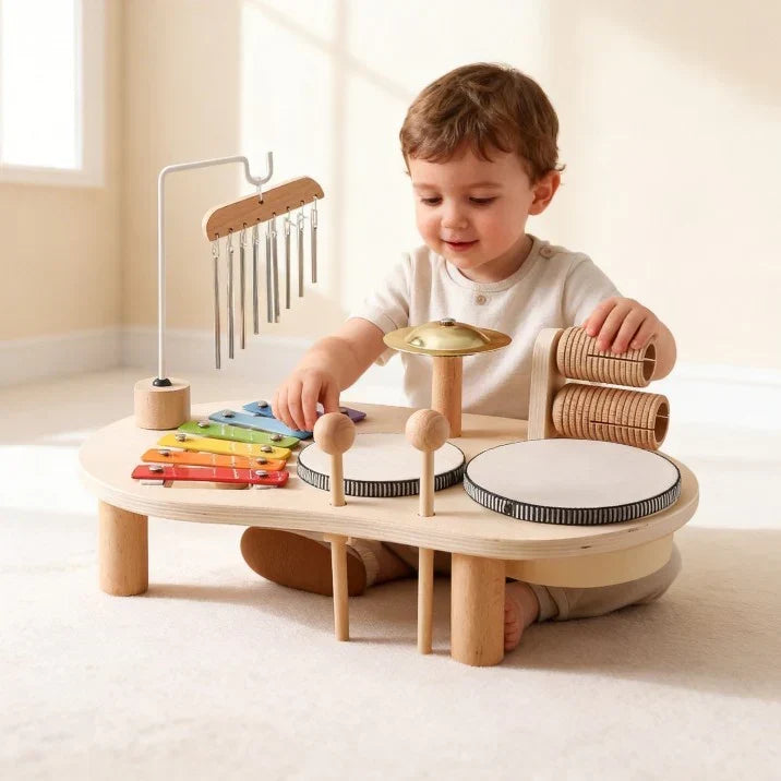Un petit garçon assis devant la table musicale joue avec la cymbale et le xylophone colorés 3