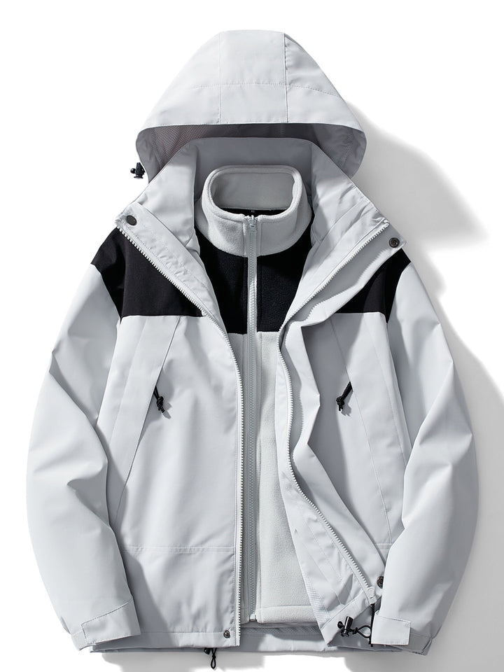 Version gris clair de la veste avec empiècements noirs aux épaules, polaire grise zippée dans la veste ouverte, vue de face. 3
