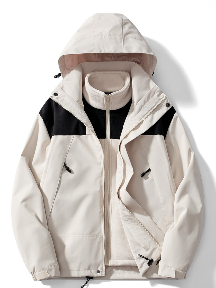 Version crème de la veste avec empiècements noirs aux épaules, polaire crème zippée visible, capuche relevée, vue de face à plat. 5