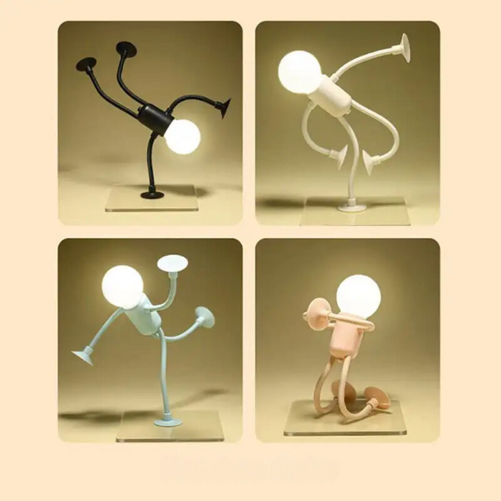 Quatre veilleuses allumées dans des poses différentes, noire, blanche, bleue et rose, sur socles transparents. 12