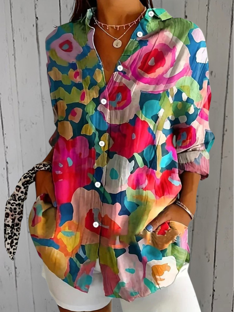 Blouse portée avec un short blanc, motif abstrait de grandes formes florales roses, bleues, vertes et jaunes. 5