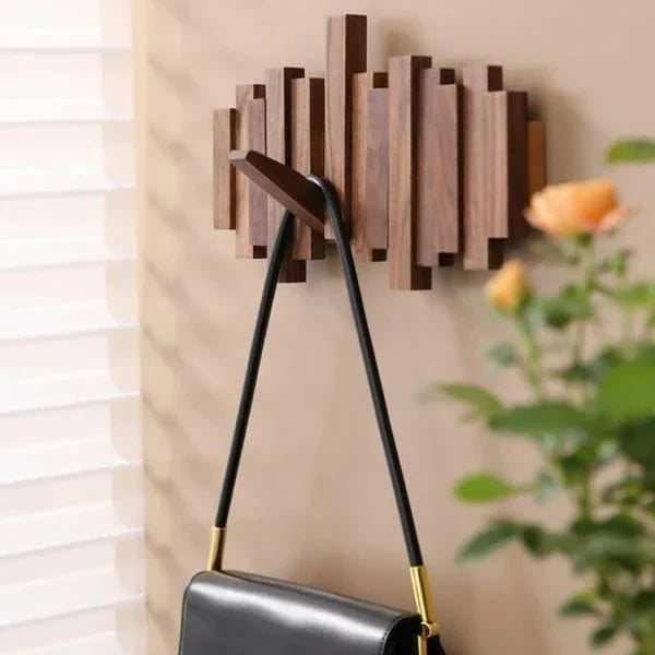 Petit portemanteau en bois foncé près d'une fenêtre et de roses, avec un sac noir suspendu 6