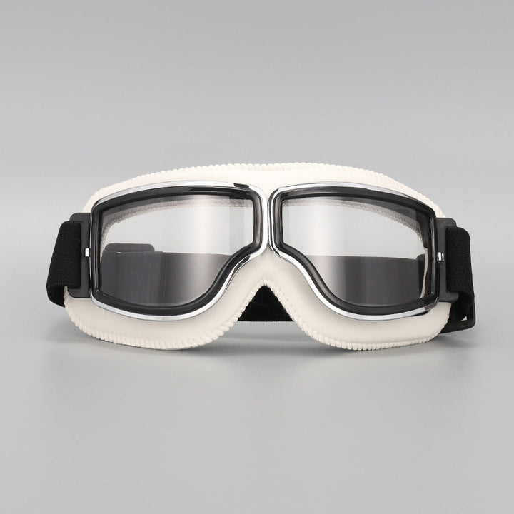 Lunettes à contour blanc crème et verres transparents, monture chromée, sangle élastique noire, vues de face sur fond gris. 13