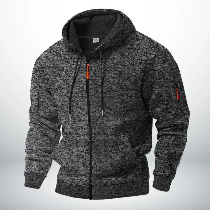 Sweat à capuche zippé chiné gris anthracite, vu de trois quarts, avec poignets côtelés, tirette orange et poche de manche zippée. 5