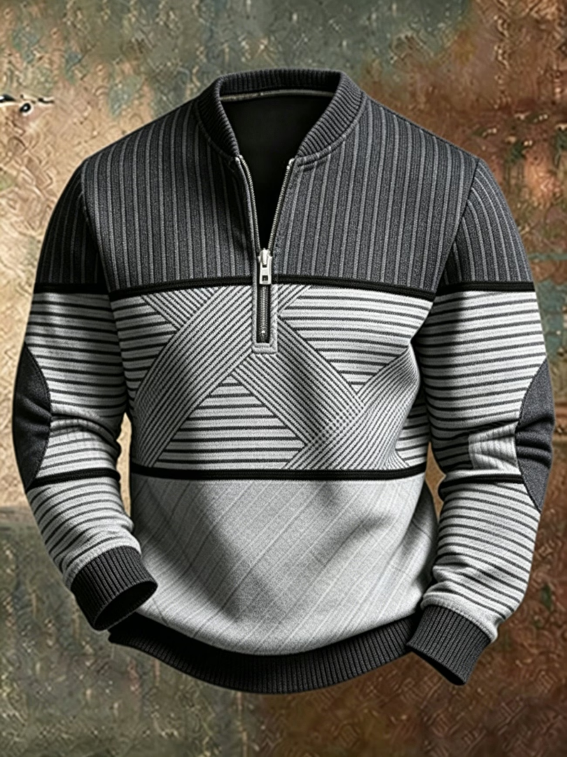 Version gris anthracite et gris clair du pull à demi-zip, avec empiècements géométriques rayés, coudières et poignets côtelés. 2