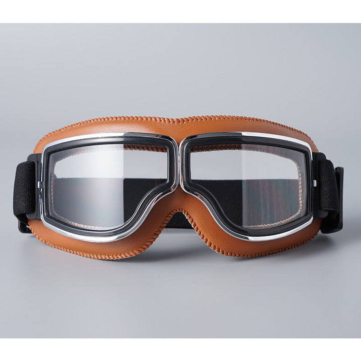 Lunettes à contour en similicuir marron clair surpiqué et verres transparents, monture chromée, sangle élastique noire. 7