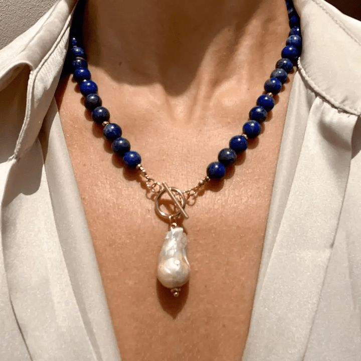 Collier porté sur un chemisier clair, grosse perle baroque nacrée au centre du décolleté 4