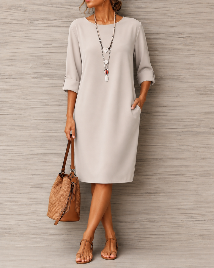 Robe gris clair à poche latérale, portée croisée de jambes avec sac en osier et sandales marron 8
