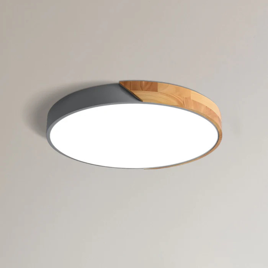 Plafonnier à coque grise et bois clair, vu de dessous sur fond uni, diffuseur allumé 8