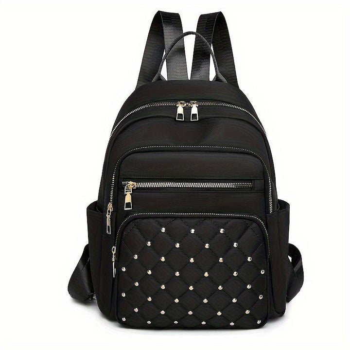 Sac à dos noir vu de face, poche matelassée ornée de petits clous dorés 1