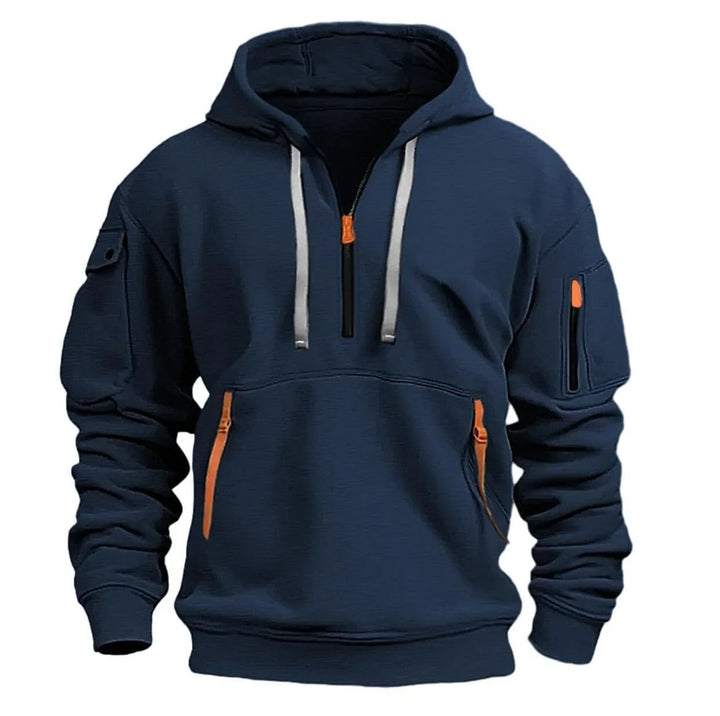 Vue de face du coloris bleu marine, avec cordons de capuche gris clair et zips orange sur la poche ventrale. 4