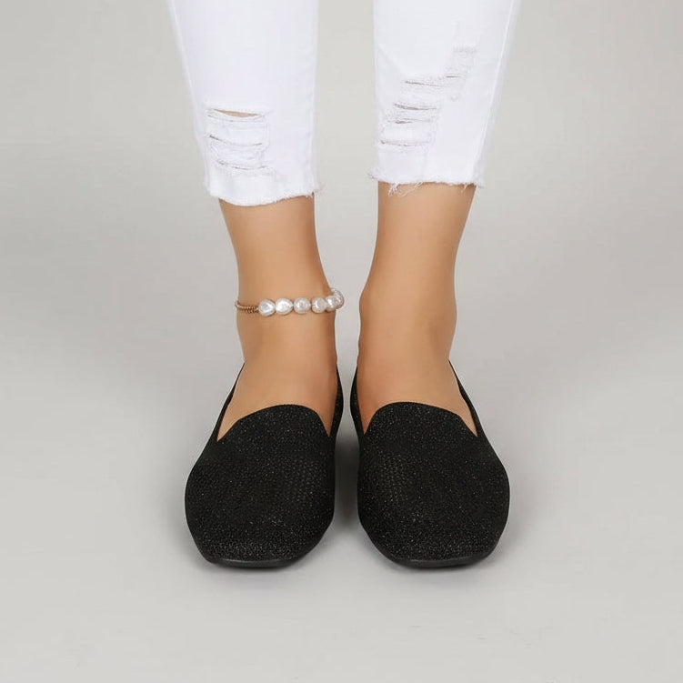 Paire noire pailletée portée de face avec un jean blanc déchiré, sur fond gris uni. 2