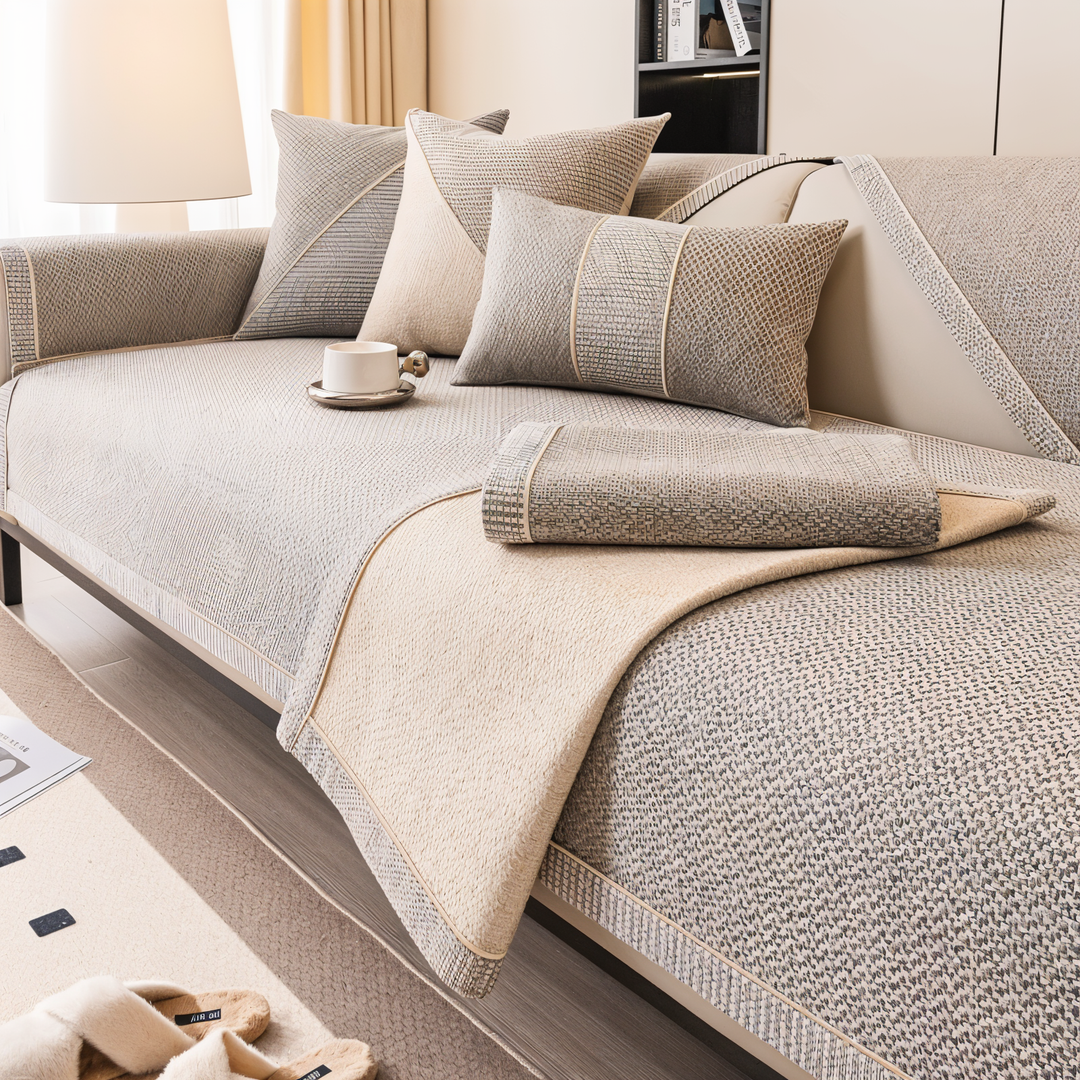 Housse beige-gris dont un pan est replié sur l'assise, révélant la face inférieure beige et le bord tissé quadrillé. 3