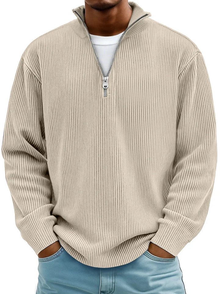 Pull côtelé beige à demi-zip porté de face par un homme, avec t-shirt blanc dessous et jean bleu clair. 7