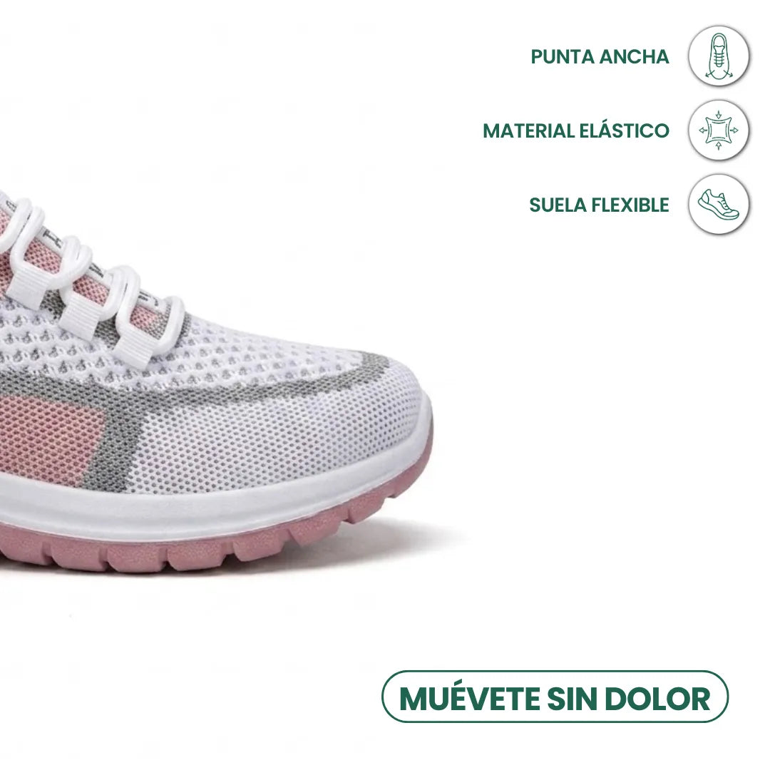 Gros plan sur l'avant d'une basket en mesh blanc, gris et rose, illustrant la pointe large, la matière élastique et la semelle flexible. 23