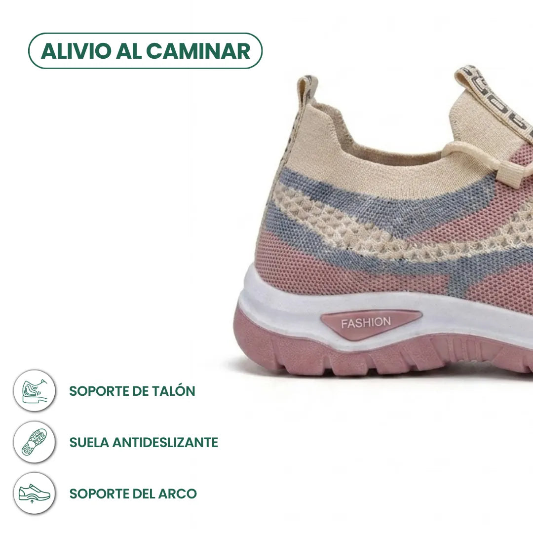 Gros plan sur le talon d'une basket en mesh beige, rose et gris-bleu, avec légende sur le maintien du talon et la semelle antidérapante. 31