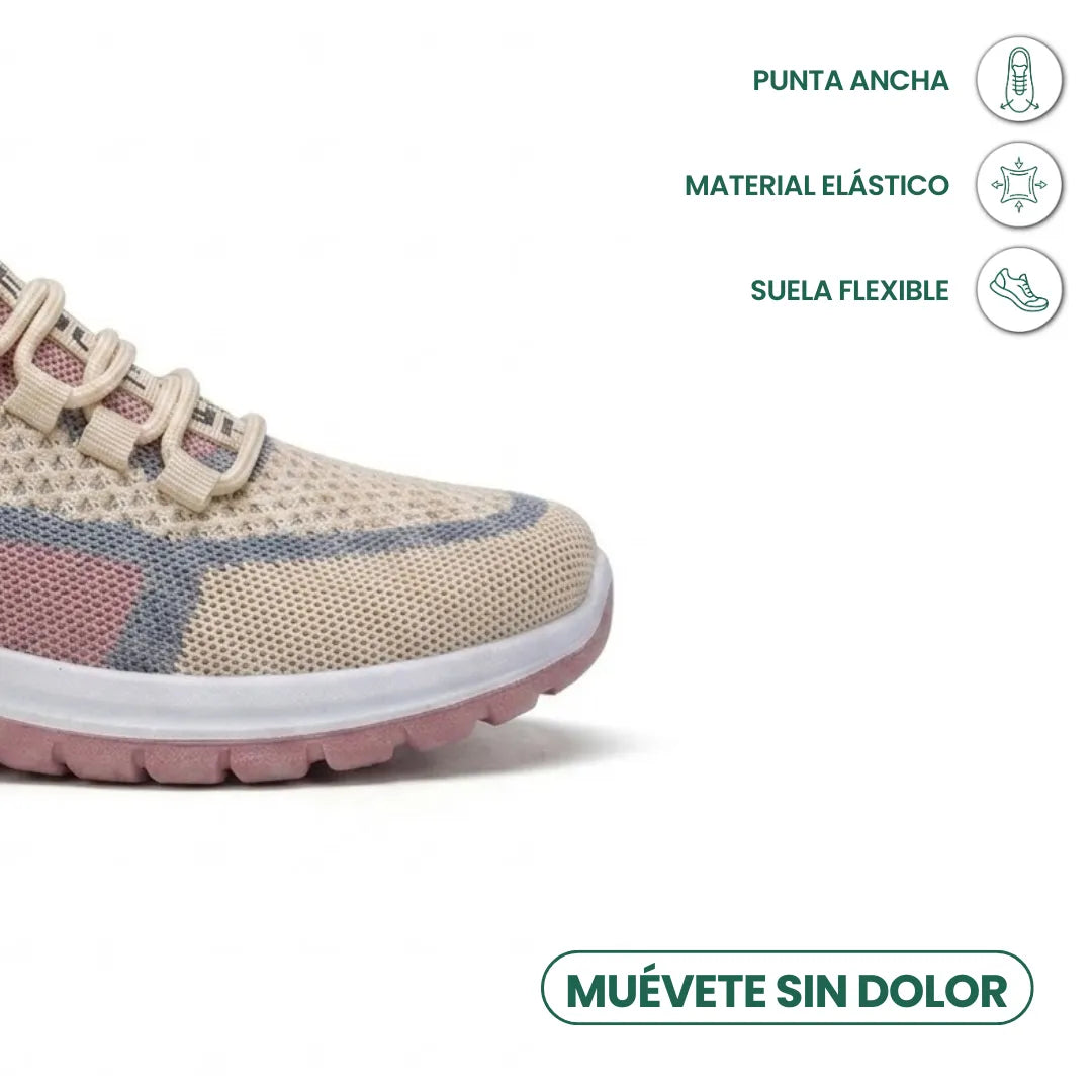 Gros plan sur l'avant d'une basket en mesh beige, rose et gris-bleu, illustrant la pointe large, la matière élastique et la semelle flexible. 32