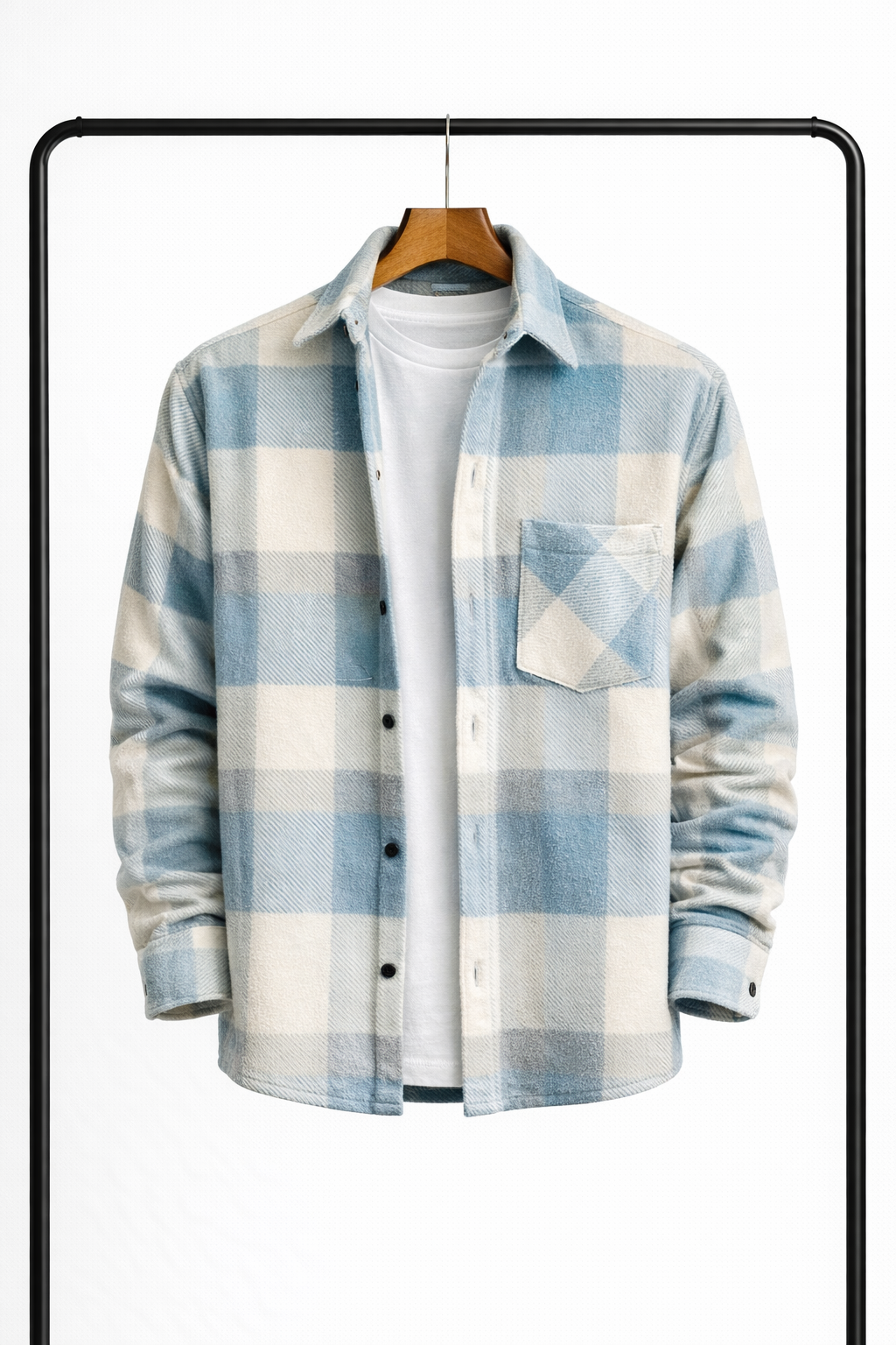 Surchemise à grands carreaux bleu ciel et écru, suspendue ouverte sur un t-shirt blanc, vue de face avec poche poitrine. 1
