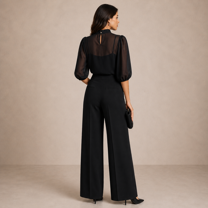 Ensemble noir vu de dos: col montant avec fermeture goutte, pantalon large à poches passepoilées 2
