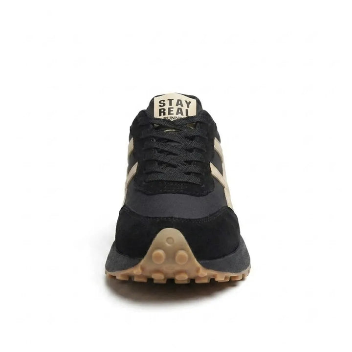 Vue de face de la basket noire à bandes beiges, lacets noirs et bout de semelle caramel 19
