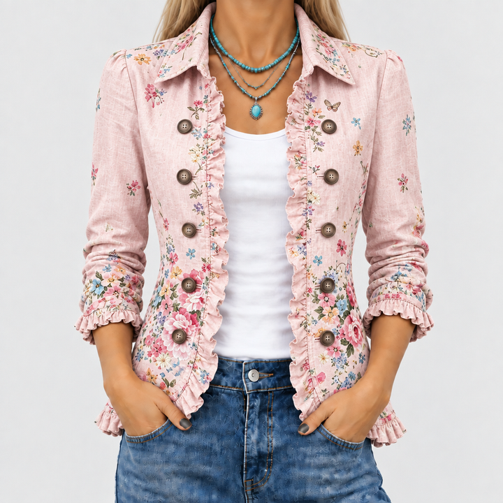Gros plan sur le devant de la veste rose à fleurs, volants le long de l'ouverture, boutons et col, portée sur un débardeur blanc. 1