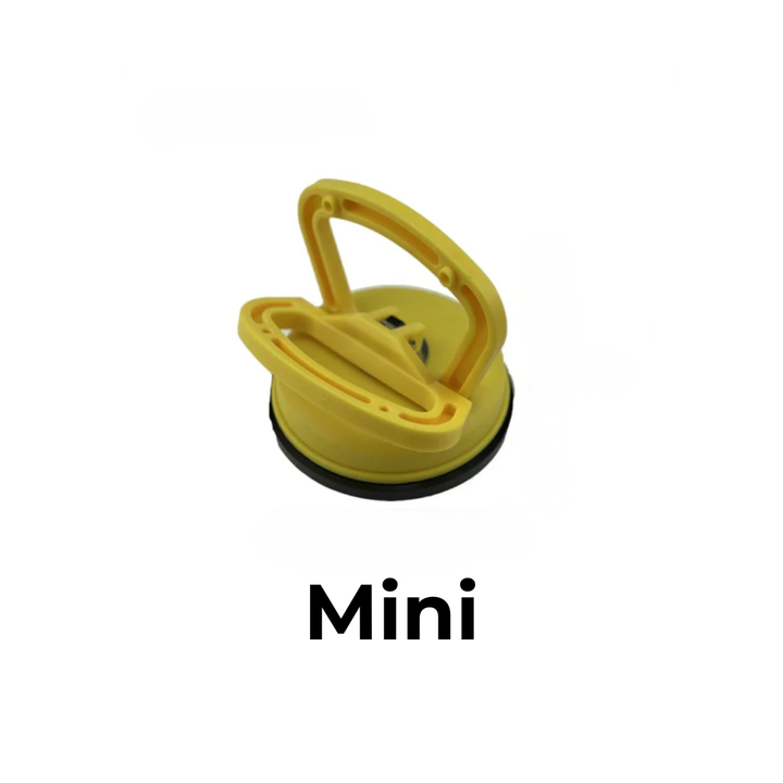 Ventouse de débosselage jaune de petit format, vue de dessus avec sa poignée relevée, sur fond blanc. 1