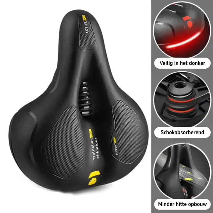 Selle noire vue de dessus, inclinée, avec zones texturées et découpe centrale, entourée de trois détails ronds : réflecteur rouge, amortisseur, ventilation. 21