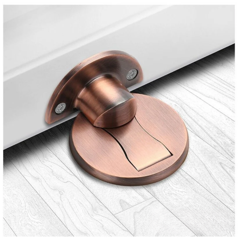 Version cuivrée de la butée magnétique, montrant le support vissé sur la porte et le socle rond sur le parquet. 5