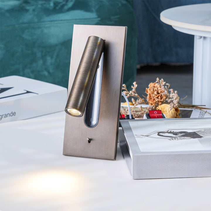 Applique bronze posée sur une table, spot allumé, avec livres et fleurs séchées autour 28