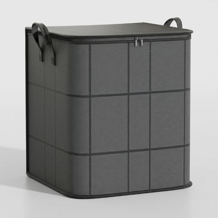 Sac de rangement gris plus haut, fermé, vu de trois quarts sur fond neutre, avec ses anses et sa fermeture éclair. 7