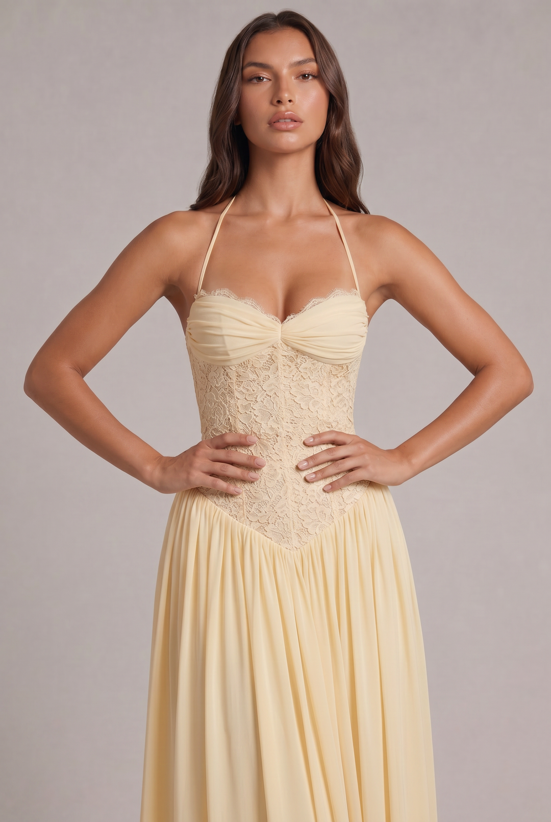 Gros plan sur le buste de la robe jaune pâle, mains sur les hanches, détail de la dentelle et des bonnets froncés. 6