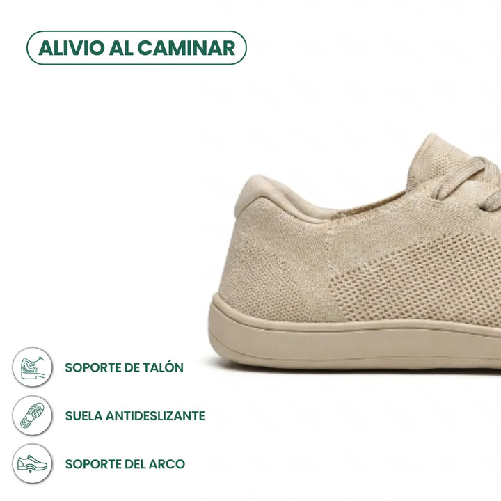 Gros plan sur le talon et la semelle de la basket beige, avec trois pictogrammes sur le maintien et l'adhérence. 4