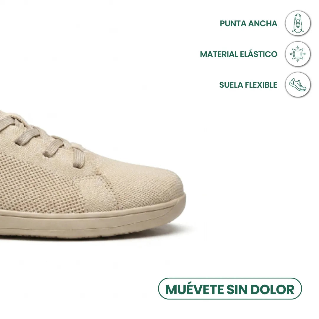 Gros plan sur le bout large de la basket beige, avec pictogrammes sur la matière élastique et la semelle flexible. 5