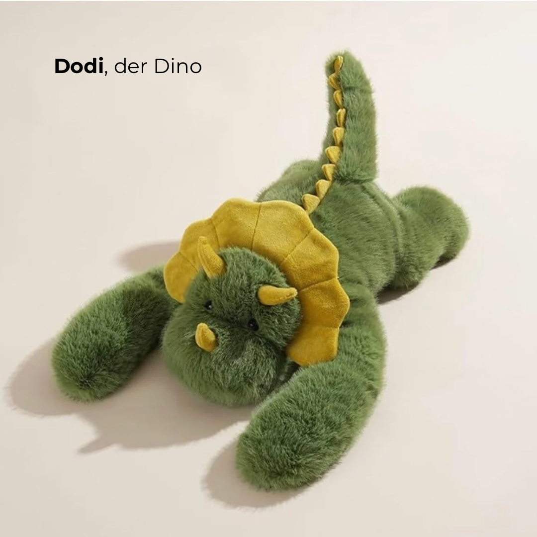 Peluche dinosaure vert à collerette et cornes jaunes, allongé avec la queue dressée, vu de dessus. 4