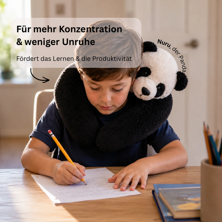 Enfant écrivant à son bureau avec la peluche panda portée autour du cou comme un coussin. 9