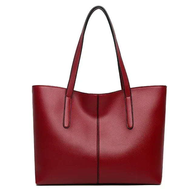 Sac cabas rouge bordeaux vu de face sur fond blanc, anses relevées et couture verticale centrale 8