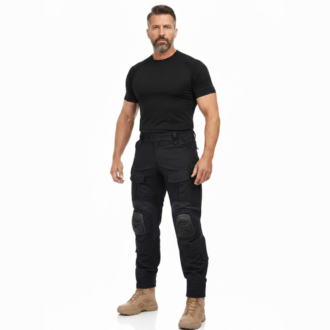Homme en pied de face, vêtu du pantalon noir, d'un t-shirt noir et de bottines beiges, sur fond blanc. 7