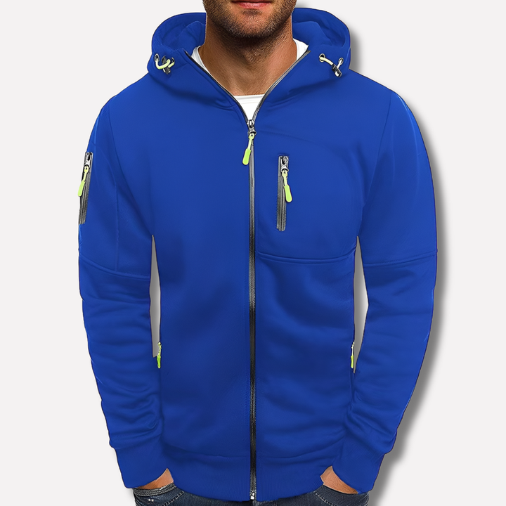 Sweat zippé bleu roi porté de face par un modèle sur fond clair, avec zips vert citron et poche sur la manche. 2